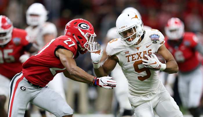 Jan 1, 2019; New Orleans, LA, USA; Texas Longhorns wide receiver Collin Johnson (9) runs against Georgia Bulldogs defensive back Eric Stokes (27) after a catch in the second half of the 2019 Sugar Bowl at the Mercedes-Benz Superdome. The Texas Longhorns won 28-21. © Chuck Cook-USA TODAY Sports